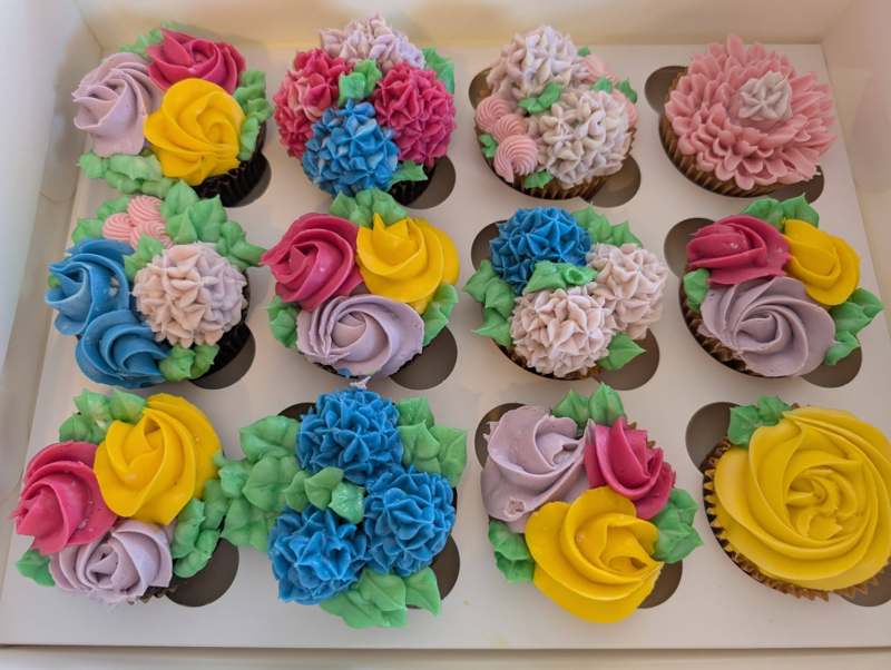 Angled view of Kelsey's hand-piped floral buttercream cupcakes